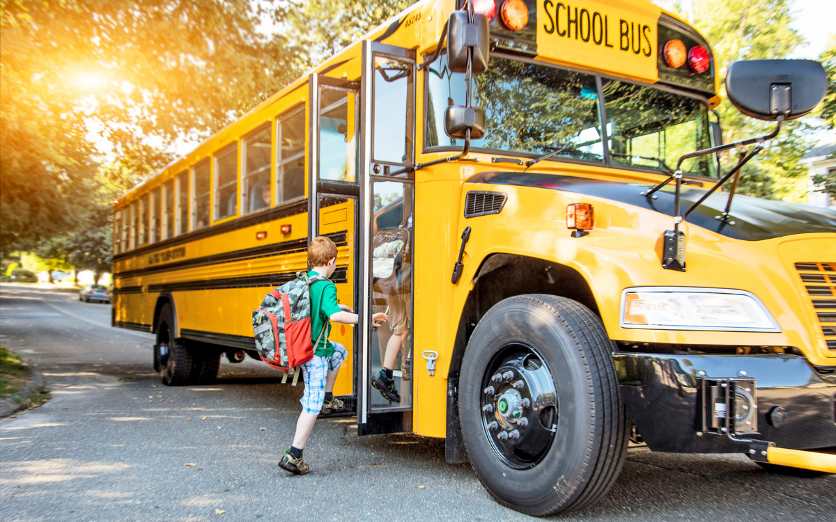 kids getting on a school bus